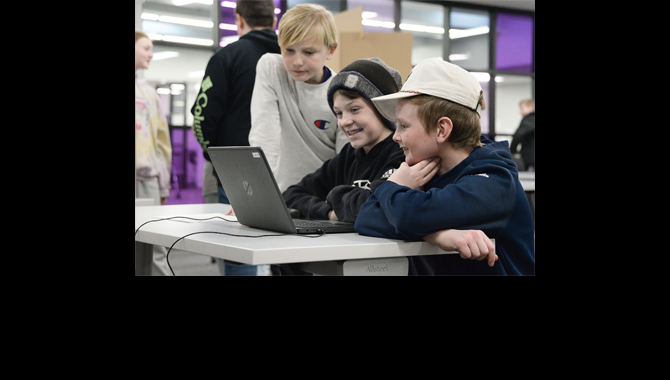 Students looking at a computer