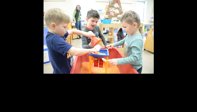 Students playing with sand table