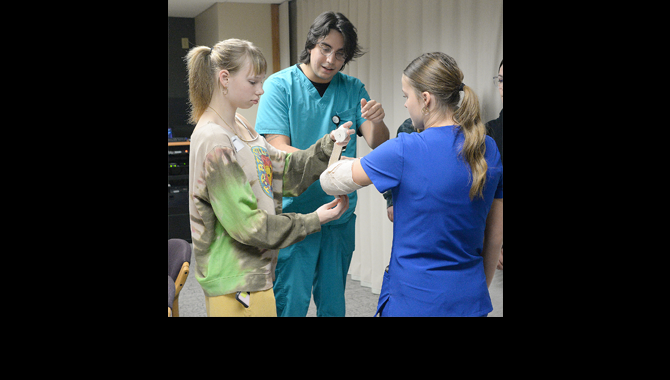 Students practicing bandaging a patient