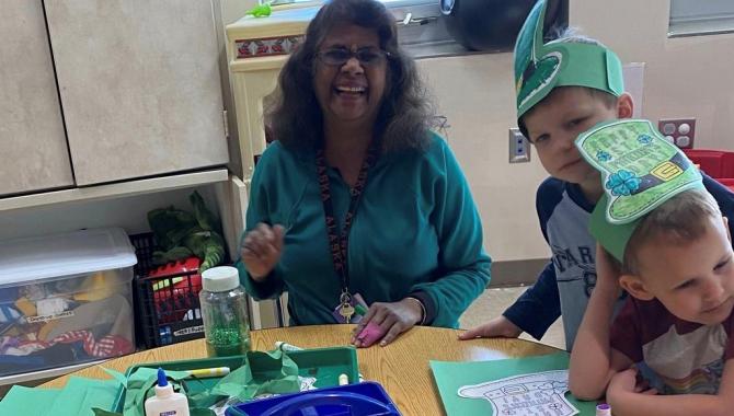 teacher with students at table