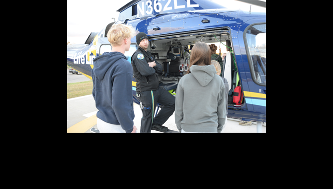 Students look at helicopter