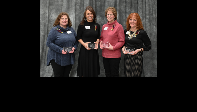 Award winners hold plaques