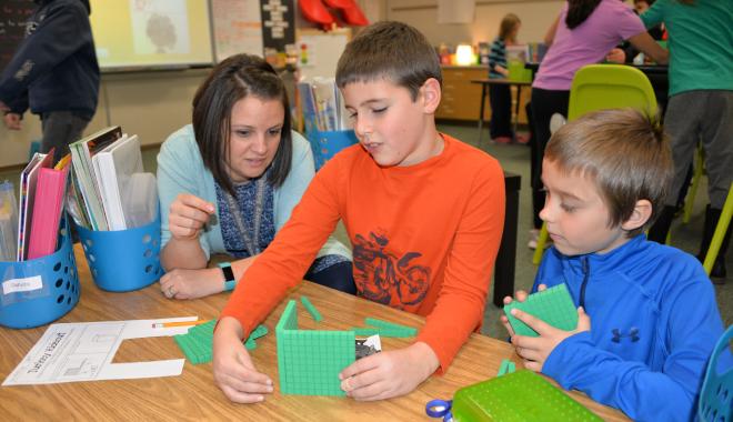 teacher working with students