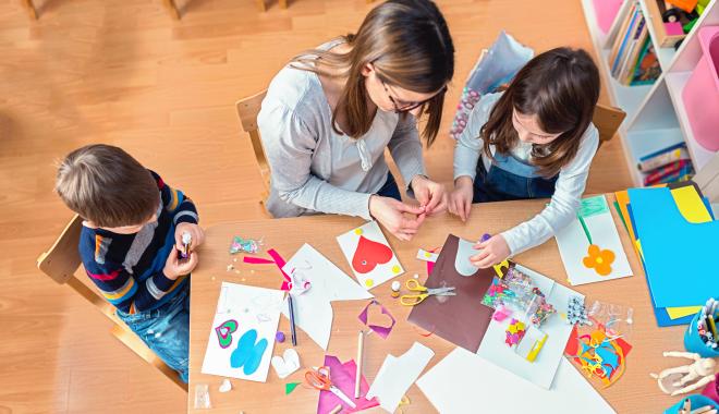 parent and kids working on an art project