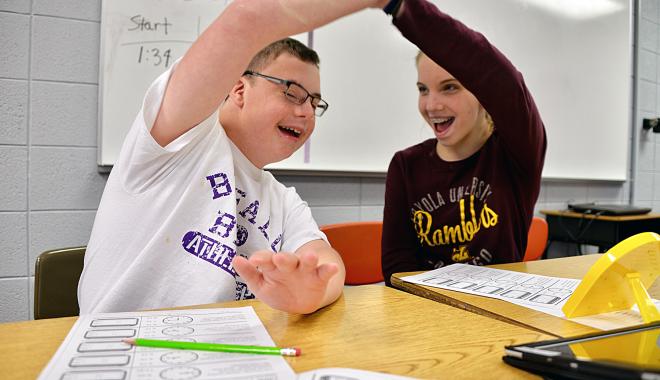 students high-fiving