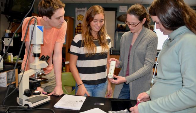 students with a teacher in science