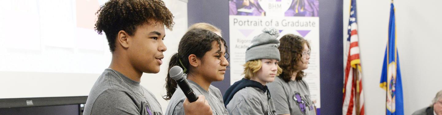 Students speaking on a panel