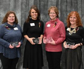 Award winners holding plaques