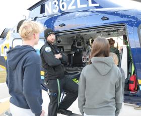 Students look at helicopter