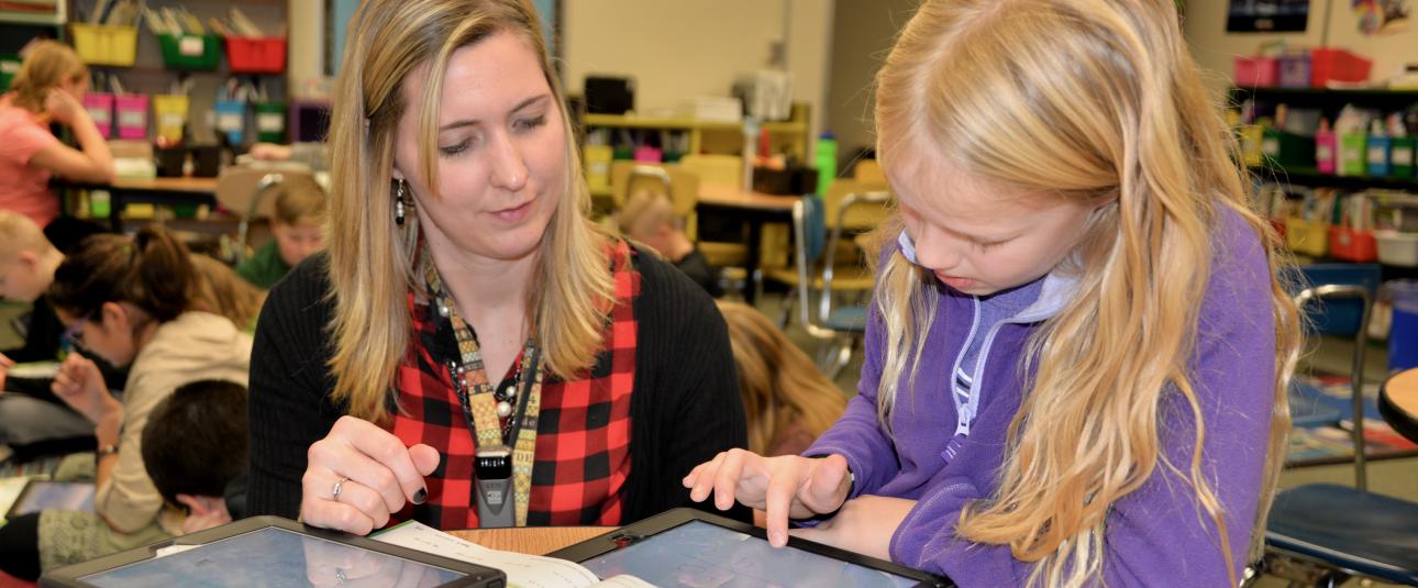 teacher helping a student